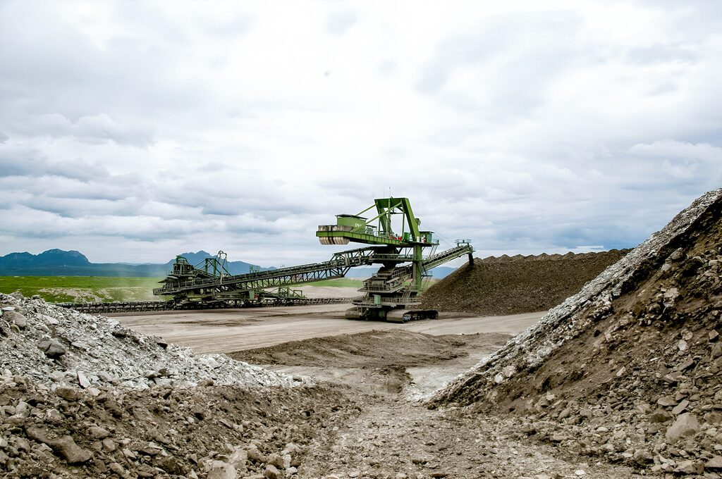 Mobile spreader system in a surface mining operation: A large, mobile machine distributing waste material efficiently over the dump site, enhancing continuous material handling